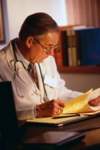 Doctor Reading Papers at Desk